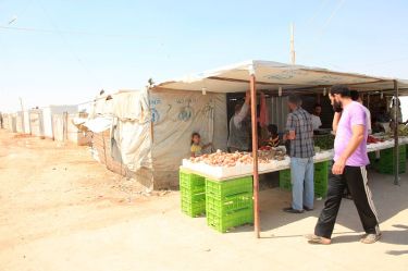 Zaatari is equivalent to Jordan's fourth largest city in terms of population, and now has over 3,000 small businesses set up by the refugees themselves, selling everything from fruit and veg to roast chicken and bridal wear. / Photo by Russell Watkins/Department for International Development